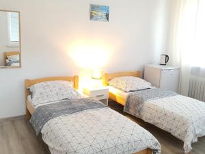 Postel nebo postele na pokoji v ubytování Anna CENTRUM - pokoje przy Plaży