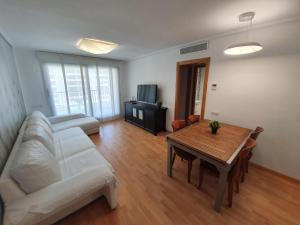 A television and/or entertainment centre at Style Apartment Patacona Beach segunda linea