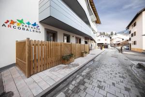 a wooden fence in front of a building at casa vacanze arcobaleno in Predazzo