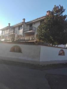 a large white building with a tree in front of it at A Santy's Rooms-BAGNOCONDIVISO SHAREDBOTH ROOM2piano-no lift-3chilom a piedi xAEROPORTO-A PAGAMENTO AIR CONDIZextra bed EXTRABED FOR A FEE-3 MINUTI BUS XFIERADIROMA-10 MINUTES STOP BUS TO ROME IN50 MINUTES TRAFFICPERMITTING ARE YOU TO ROME in Fiumicino +31 photos