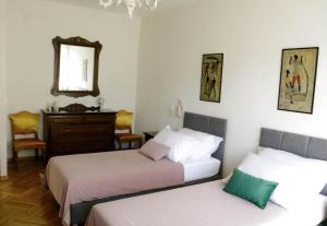 a bedroom with two beds and a mirror and a dresser at Luxury Suite Jasmin in Split