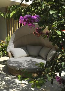 a wicker couch sitting on a patio with flowers at Luxury Suite Jasmin in Split