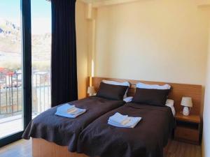 Letto o letti in una camera di Hotel Horizon Kazbegi
