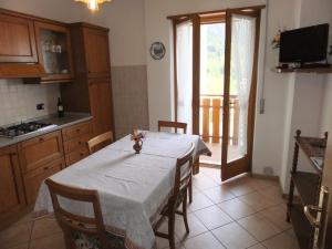 a kitchen with a table with a white table cloth at Casa Endrizzi in Fai della Paganella +25 photos