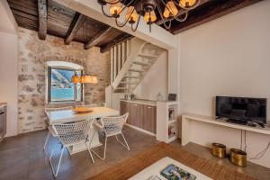 a kitchen and dining room with a table and chairs at 18th Century Villa in the UNESCO Bay of Kotor in Kotor
