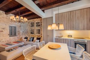 a kitchen and living room with a table and chairs at 18th Century Villa in the UNESCO Bay of Kotor in Kotor