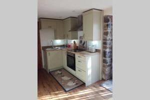 a kitchen with a mess in the floor at Farm accommodation - The Lizard Peninsula, Cornwall in Helston