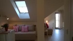 a living room with a couch and a skylight at Bursztynowy 2 in Karwia