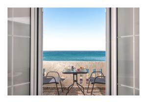 a view of the ocean from a room with a table and chairs at Kastri Mare Sea View Residences by Estia in Keratokampos