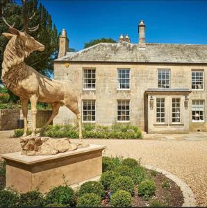 a statue of a deer in front of a house at Walwick Hall Country Estate and Spa in Hexham