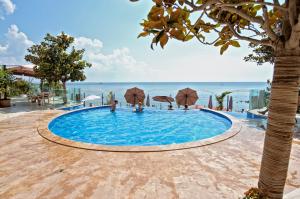 a swimming pool with a view of the ocean at Dreams in La Mer in Golden Sands