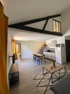 a living room with a table and a dining room at appartement au coeur de Loupiac in Loupiac-de-Cadillac