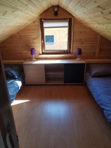 a room with a desk and a window in a cabin at Gucio in Zwierzyniec