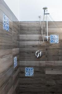 a bathroom with a shower with wooden tiles at Villa Cinzia-150 mt from the beach in Mondello +37 photos