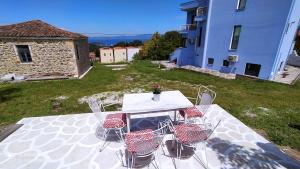 a table and chairs sitting on top of a yard at BLUE HOUSE in Paliouri