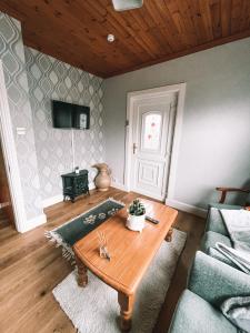 a living room with a table and a couch at St Anthonys B&B in Dungarvan