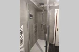 a shower with a glass door in a bathroom at The Cottage - Hot Tub - nr Glasgow - self check-in in Coatbridge