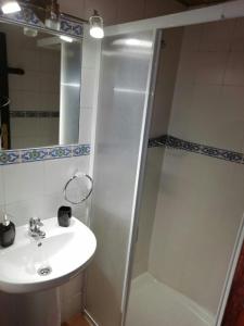 a bathroom with a sink and a shower at Molino de Louzao in Palas de Rei