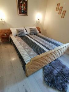 een groot houten bed in een kamer met: bij Vacation house Dora in Malinska