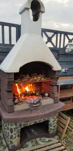 a brick oven with a fire inside of it at Wolnostojący dom na dużym prywatnym terenie -pet friendly- in Lubin