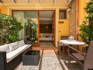 a patio with a white couch and a table at B&B Giglio di Chia in Domus de Maria