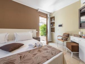 a bedroom with a large bed and a chair at Giglio di Chia - Your Dream Holiday in Domus de Maria