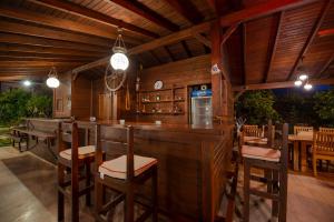 a bar in a restaurant with wooden walls and chairs at Gocek Arion Hotel in Göcek