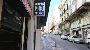 a sign for a hotel on the side of a street at Athens Psiri Hotel in Athens