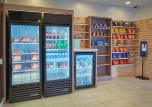 a store front with a refrigerator filled with ice cream at Holiday Inn Express Hotel and Suites Akron South-Airport Area, an IHG Hotel in Akron