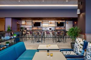 a restaurant with tables and chairs and a bar at Hyatt House Tampa Downtown in Tampa