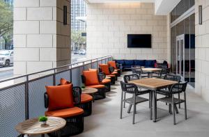 a row of tables and chairs on a balcony at Hyatt House Tampa Downtown in Tampa