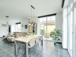 a dining room and living room with a table and chairs at Beautiful house in Flemish Ardennes for cyclists in Ronse