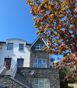 a house with a balcony on top of it at 3 Bedroom House located in Centre of Carndonagh in Carndonagh