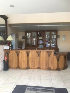 a large wooden bar in a room with at Logis Hôtel restaurant Les Minotiers in Mirepoix