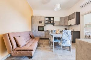 a living room with a couch and a table at Villino Vanessa by BarbarHouse in Torre Lapillo +13 photos