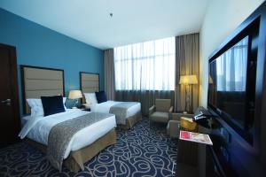 Voodi või voodid majutusasutuse Ramada Abu Dhabi Corniche toas