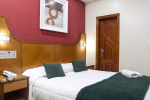 Postel nebo postele na pokoji v ubytování Capri Hotel