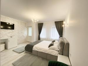 a bedroom with a large bed and a television at Casa Ina in Moisei +39 photos