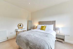 a bedroom with a large bed with a yellow pillow at Host & Stay - Strathview in Hexham