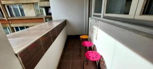 two chairs with lady bugs on them sitting on a balcony at apartman centar S in Pirot