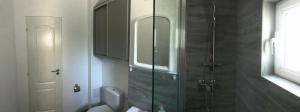 a bathroom with a toilet and a glass shower at Apartament Langa Plaja Diana in Mangalia +39 photos
