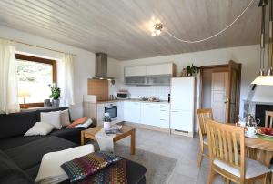 a living room with a couch and a table at Haus Margarete & Landhaus Karin in Zwiesel