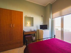 A bed or beds in a room at Filoxenia Hotel
