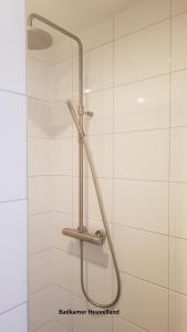 a shower with a shower head in a bathroom at B&b Broodhuis Kerkrade in Kerkrade