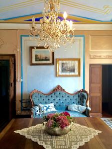 a room with a couch and a basket of flowers on a table at AGRITURISMO CASA OLIVIERI in Sestri Levante