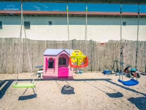 a playground with a swing set and a swing at The Old Border in Vama Veche