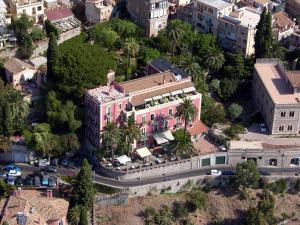 a large building with a lot of trees at Hotel Villa Schuler in Taormina