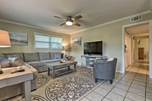 a living room with a couch and a table at Ocean Springs Getaway - Walk to Beach and Downtown! in Ocean Springs