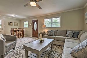 a living room with a couch and a table at Ocean Springs Getaway - Walk to Beach and Downtown! in Ocean Springs