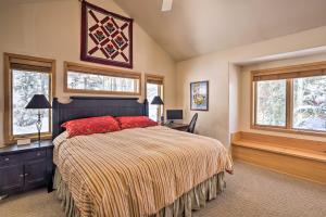 a bedroom with a bed and a desk and windows at Slopeside Sanctuary - Penthouse Less Than 1 Mi to Lifts! in Winter Park